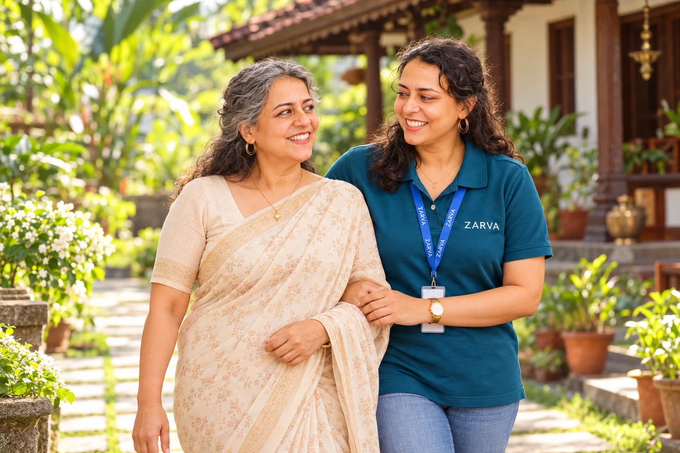 Care partner and older woman in a Kerala garden