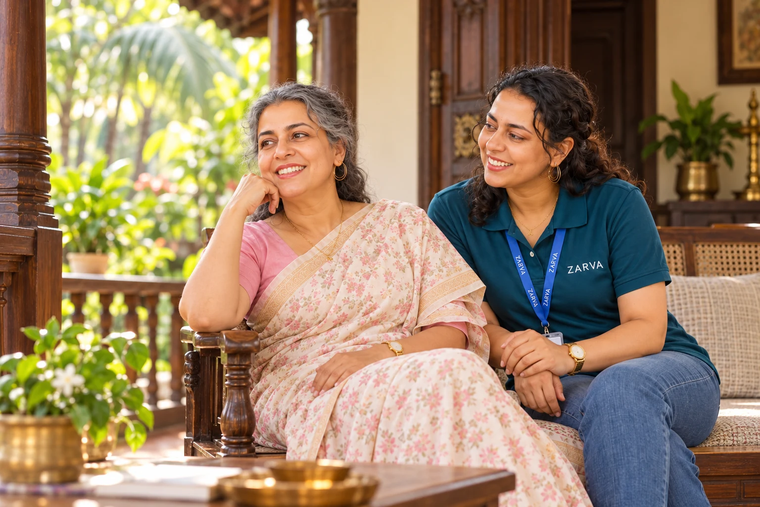 Illustration of an older Kerala woman sharing a quiet moment with a companion on a leafy home veranda.